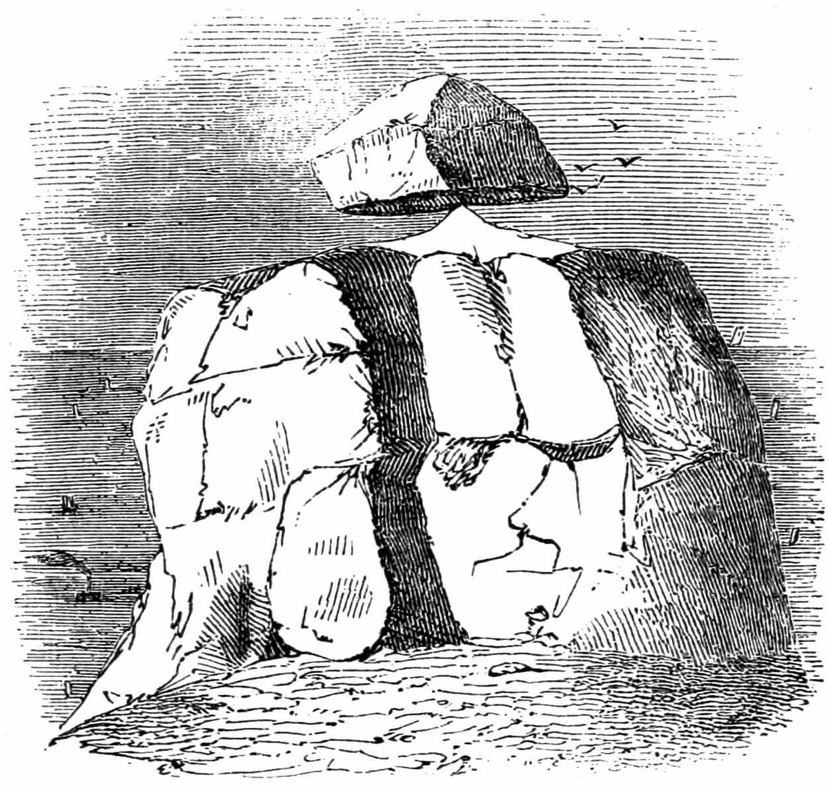 rock balancing on point of a larger rock